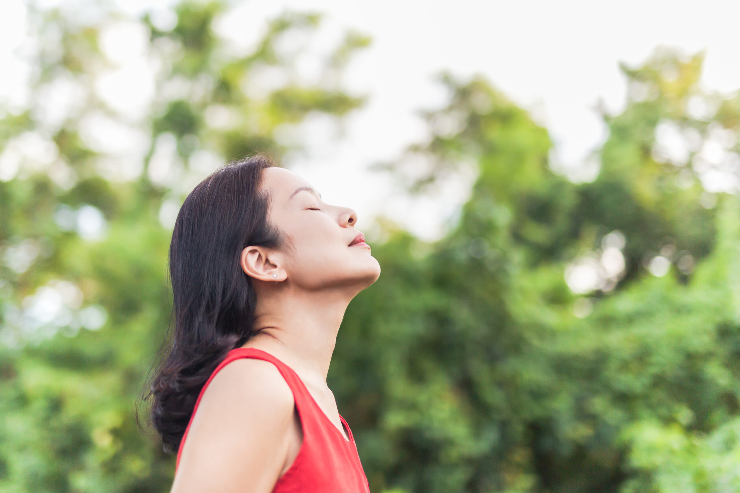 Portrait of beautiful woman feeling alive breathing fresh air with closed eyes.