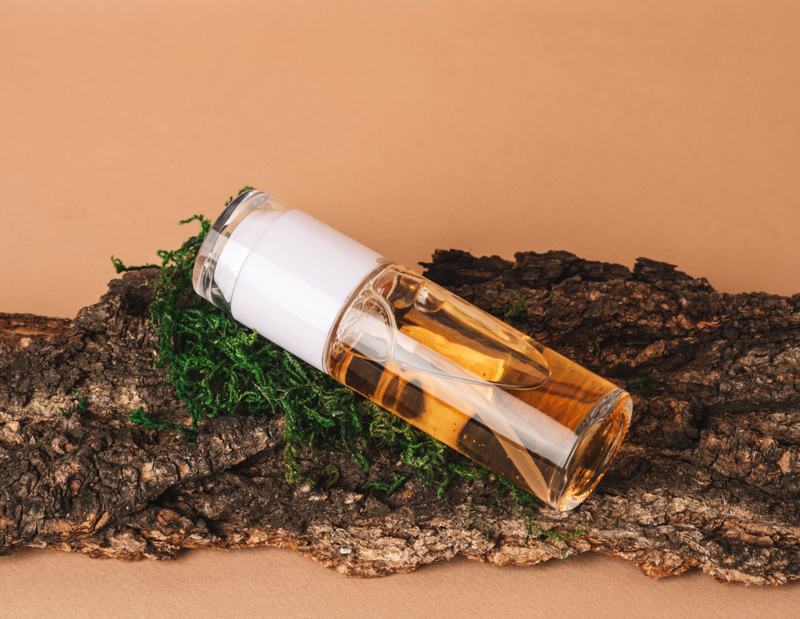 Cosmetic container with skin care product on a beige background with natural materials